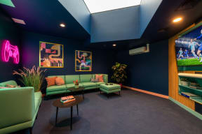 a waiting room with green couches and a table
