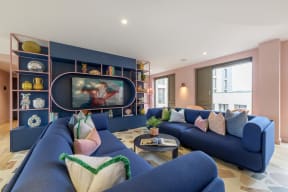a living room with blue couches and a tv