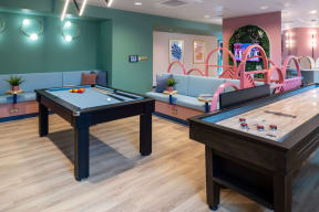 two billiards tables in a game room with a pool table