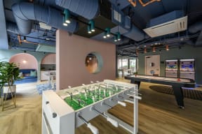 a room with a row of tennis rackets and a pool table