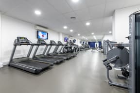 the gym at the hyperion hotel hamburg showcasing cardio equipment