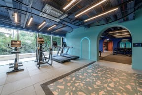 a workout room with weights and a large glass window