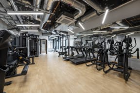a large fitness room with weights and exercise machines