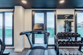 a home gym with a view of the water