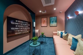 a living room with a couch and a motivational quote on the wall