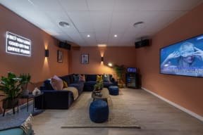 a living room with couches and a tv on the wall