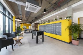 a game room with a foosball table and a yellow wall