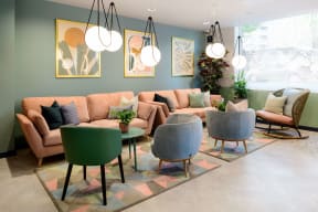 a living room with couches and chairs and a rug