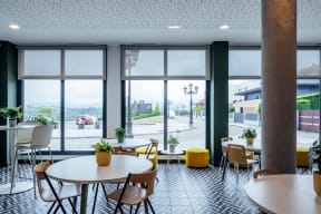 a room filled with tables and chairs and large windows