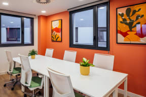 a conference room with a long white table and chairs