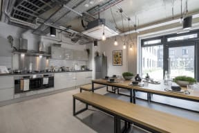 a kitchen with a long wooden table and a large window