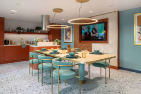 a dining room with a table and chairs and a tv on the wall