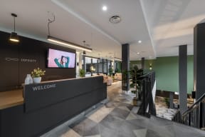 a lobby with a reception desk and a tv