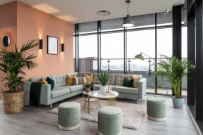 a living room with couches and tables and a large window