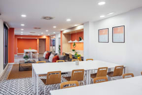 a dining room and living room with white tables and chairs