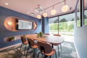a conference room with a table and chairs and a large window