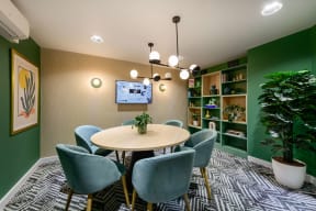 a dining room with a table and chairs and a tv