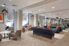 a large lobby with couches and chairs and tables