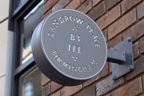 a sign on the side of a brick building