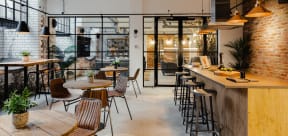 a restaurant with exposed brick walls and wooden tables and chairs