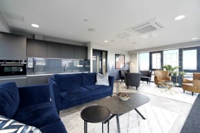 a living room with blue couches and a coffee table