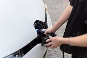 A person is charging an electric car at The Foundry Apartments, Bordon