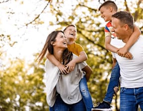 A family of three is having fun outdoors at Origins Apartments, Cambridge