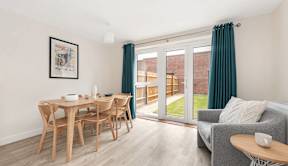 A dining room with a wooden table and chairs at Origins Apartments, Cambridge