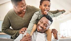 Family with a child having fun together at The Woodlands Apartments, Milton Keynes, MK5 6GS