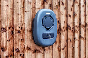 A blue device with the letters BG SYNC on it is mounted on a wooden wall at The Woodlands Apartments, Milton Keynes