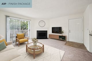 A living room with a fireplace and a television