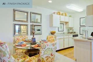 A kitchen with a dining table set for two