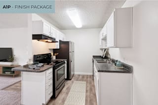 A modern kitchen with black and white appliances and cabinets