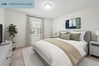 A bedroom with a large bed and a television