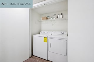 A white washing machine and dryer in a small laundry room