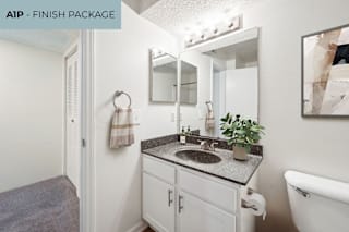 A small bathroom with a sink and mirror