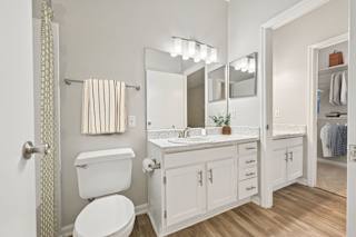 A white toilet is next to a sink in a bathroom.