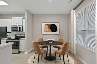 A modern kitchen with a dining table set for four.