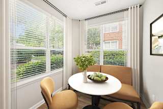 A dining room with a table and chairs.