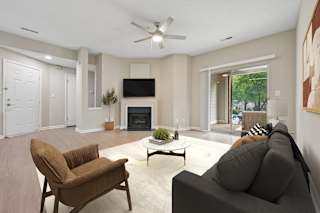A living room with a brown chair and a grey couch.