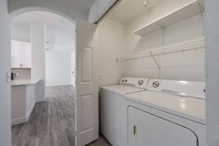 A white laundry room with a washer and dryer.