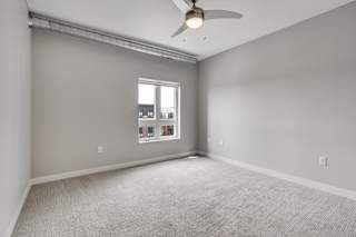Carpeted Bedroom With Ceiling Fan & Light