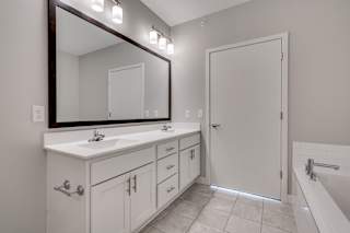Spacious Bathroom With Tiled Flooring