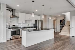 Spacious High End Kitchen With White Cabinetry