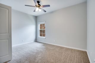 Carpeted Bedroom With Large Window