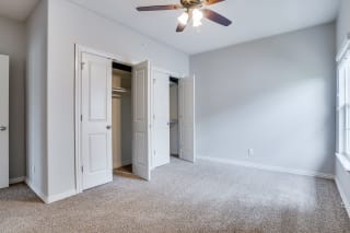 Carpeted Bedroom With Dual French Closet Doors