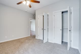 Bedroom With Light Grey Walls and Ceiling Fan