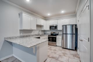 Kitchen With White Cabinets, Granite Countertops & Stainless Steel Appliances