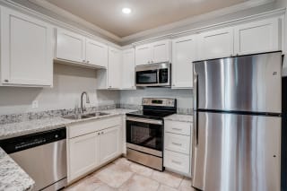 Kitchen With Stainless Steel Appliances & Tiled Flooring