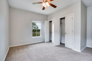 Carpeted Bedroom With Dual Closets
